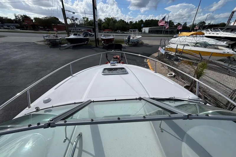 Slide: The Image of 2007 Chaparral Signature 250 boat on display at a dealership with other boats. - 21