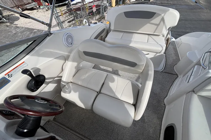 Slide: The Image of 2007 Chaparral Signature 250 boat interior with white seating and steering wheel. - 22