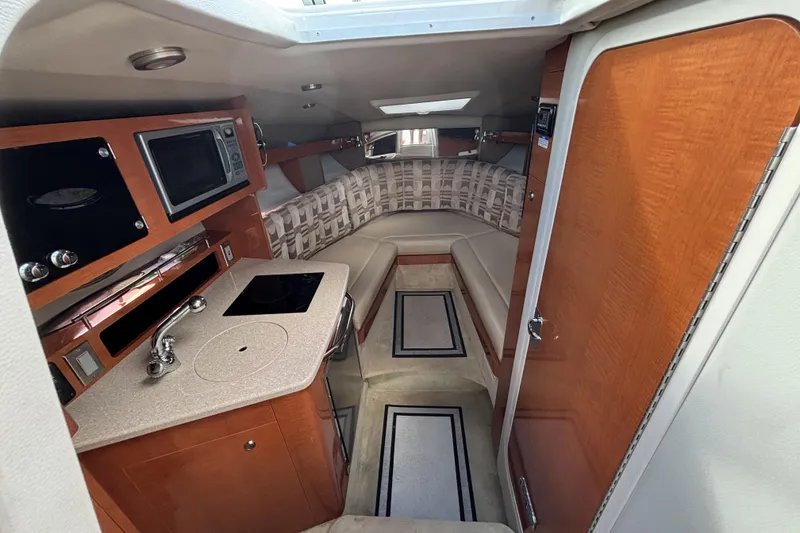 Slide: The Image of 2007 Chaparral Signature 250 cabin interior with kitchenette and seating area. - 24