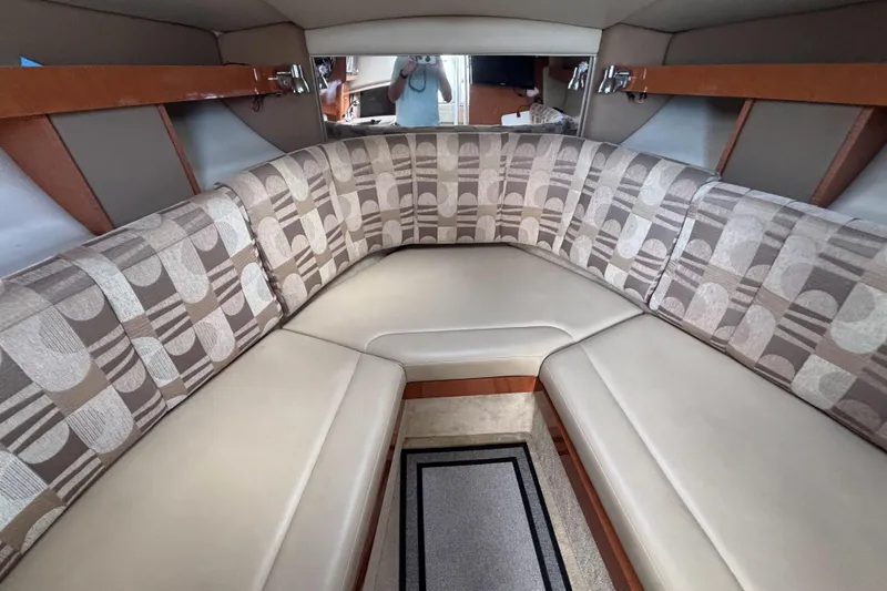 Slide: The Image of 2007 Chaparral Signature 250 cabin interior with patterned seating and wood accents. - 27