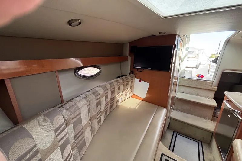 Slide: The Image of Interior of 2007 Chaparral Signature 250 boat with seating, TV, and stairs to deck. - 30
