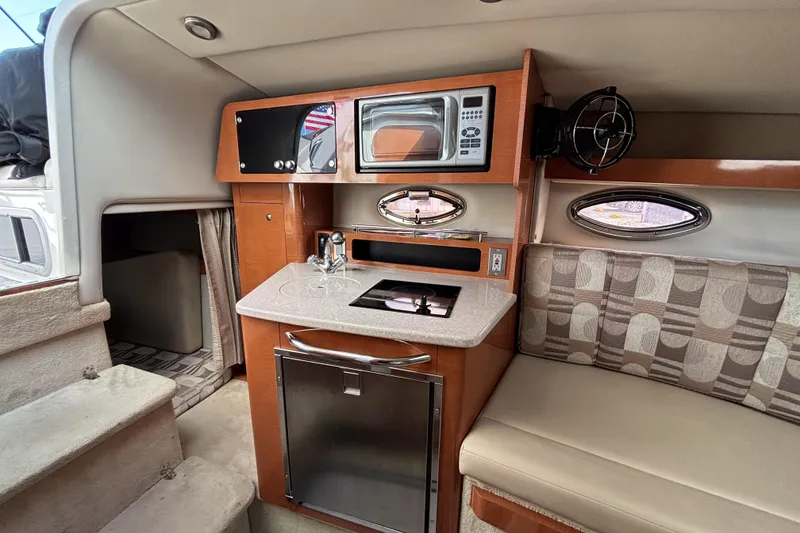 Slide: The Image of 2007 Chaparral Signature 250 cabin interior with kitchenette and seating area. - 32