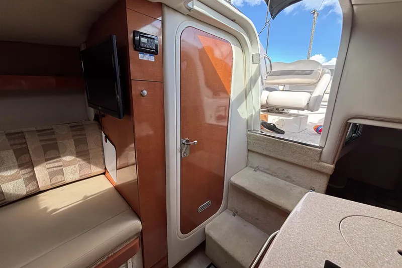Slide: The Image of 2007 Chaparral Signature 250 interior with seating, TV, and cabin door. - 33