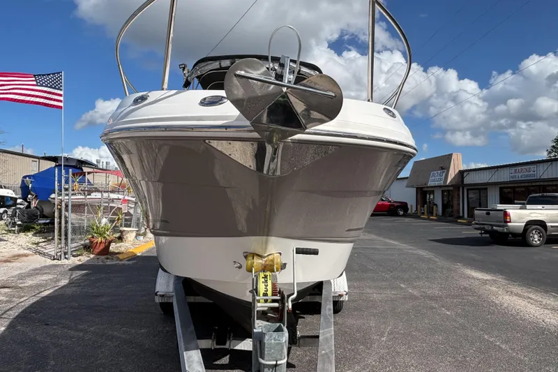 Slide: The Image of 2007 Chaparral Signature 250 boat on trailer, American flag, cloudy sky background. - 6