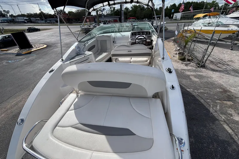 Slide: The Image of 2007 Chaparral Signature 250 boat interior with seating and dashboard, parked outdoors. - 9
