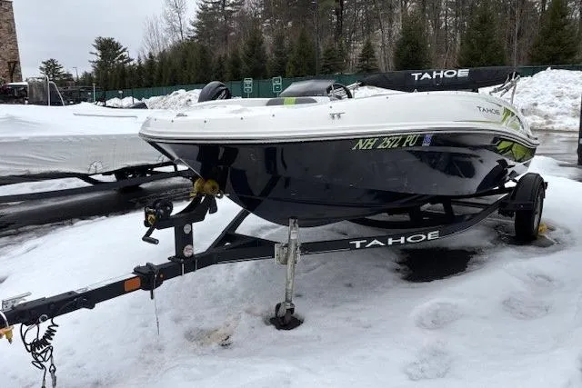 Slide: The Image of 2021 Tahoe T16 boat interior with gray and green seating, steering wheel, and controls. - 2