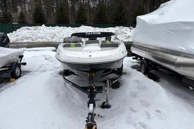 Slide: The Image of 2021 Tahoe T16 boat with outboard motor, parked on wet pavement. - 3