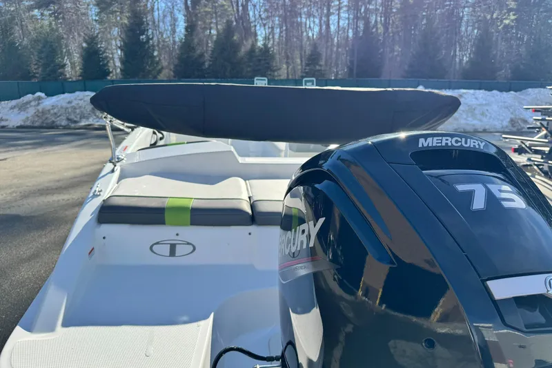 Slide: The Image of 2021 Tahoe T16 boat with Mercury 75 engine, parked outdoors in snowy setting. - 7