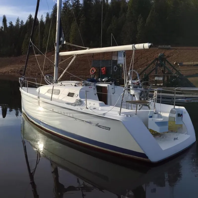 The Image of 2008 Hunter 27 sailboat cruising on open sea under clear skies. - 0