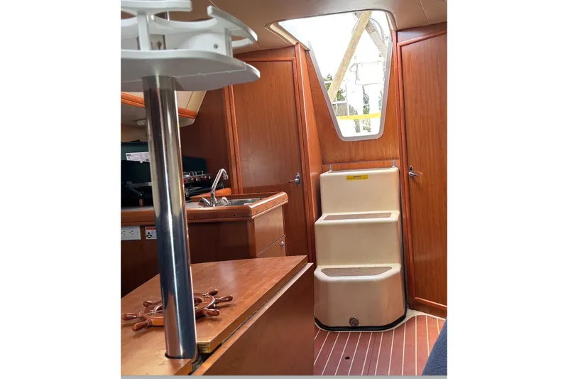 Slide: The Image of Interior view of 2008 Hunter 27 sailboat with blue ambient lighting. - 11