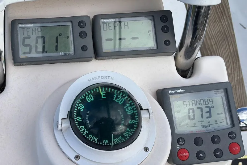 Slide: The Image of Control panel of a 2008 Hunter 27 boat with electrical switches and hazard warning. - 8