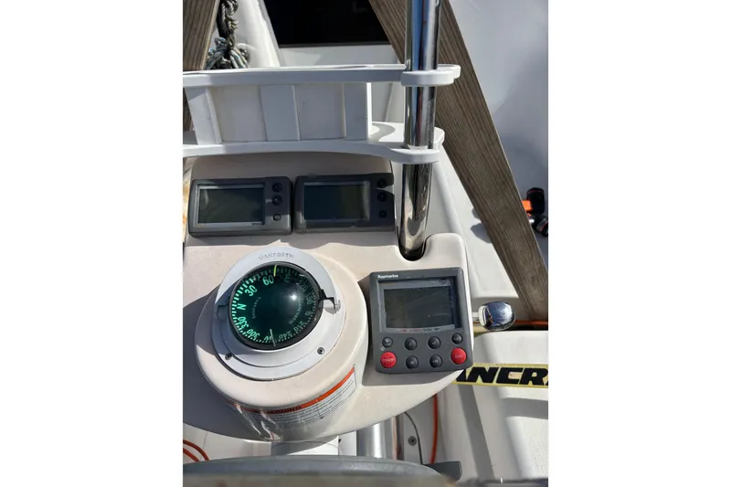 Slide: The Image of Control panel of a 2008 Hunter 27 sailboat with compass and Raymarine displays. - 9