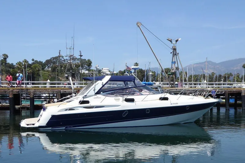The Image of 2004 Cranchi Endurance 41 yacht docked at a marina with clear skies. - 0