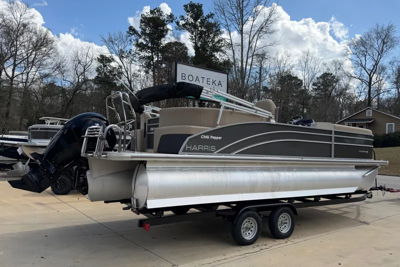 Slide: The Image of 2024 Harris Cruiser 230 pontoon boat on trailer at Boateka dealership. - 2