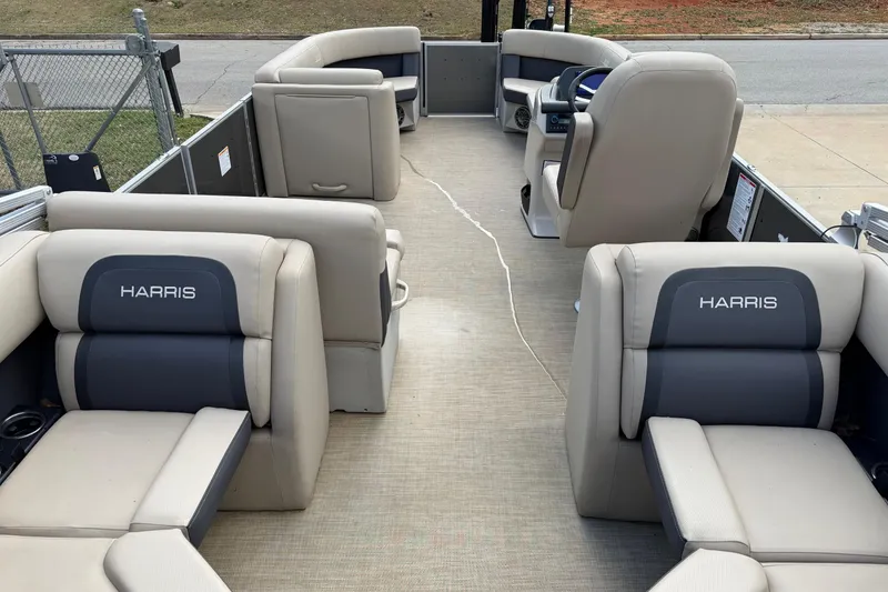 Slide: The Image of 2024 Harris Cruiser 230 pontoon boat interior with beige and gray seating. - 3