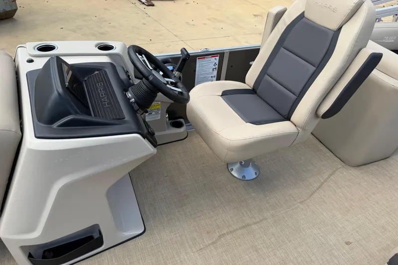 Slide: The Image of 2024 Harris Cruiser 230 boat interior with steering console and comfortable captain's chair. - 7
