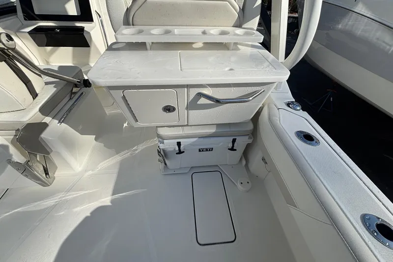 Slide: The Image of 2026 World Cat 265 DC-X boat interior with seating, storage, and Yeti cooler. - 10