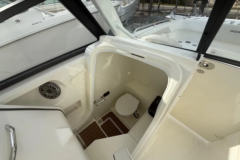 Slide: The Image of 2026 World Cat 265 DC-X boat interior with compact marine toilet and speaker. - 11