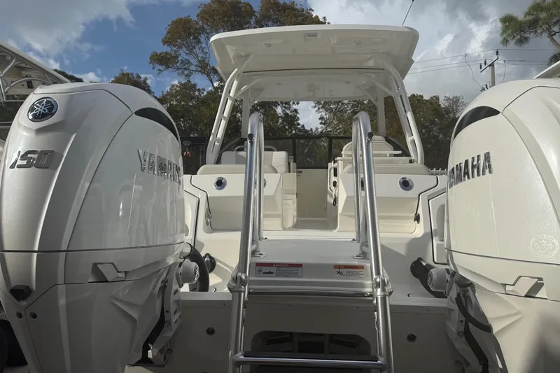 Slide: The Image of 2026 World Cat 265 DC-X boat with dual Yamaha 150 engines, rear view. - 12