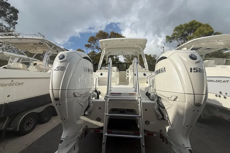 Slide: The Image of 2026 World Cat 265 DC-X boat with twin Yamaha 150 engines, docked outdoors. - 13