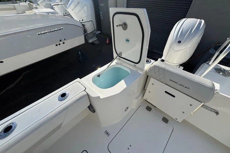 Slide: The Image of 2026 World Cat 265 DC-X boat interior with open storage compartment and seating. - 8