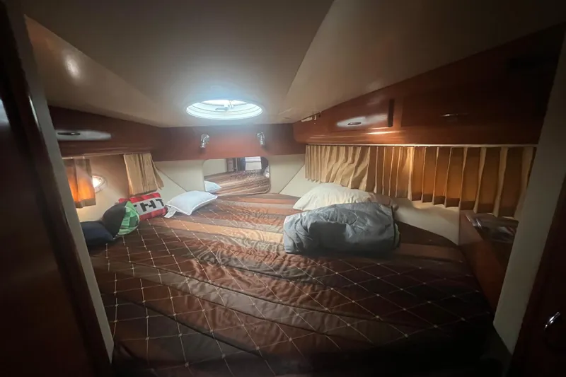 Slide: The Image of Cozy bedroom in 2004 Carver 366 Motor Yacht with plush bedding and warm lighting. - 10