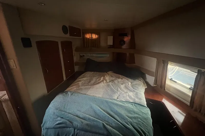 Slide: The Image of Cozy bedroom interior of 2004 Carver 366 Motor Yacht with bed and window view. - 11
