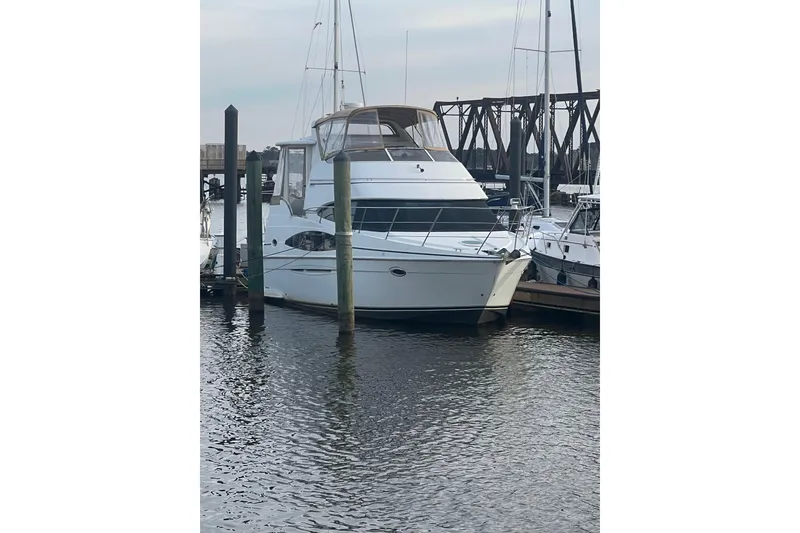 Slide: The Image of 2004 Carver 366 Motor Yacht docked at marina, calm water, overcast sky. - 13