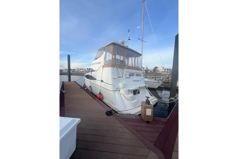Slide: The Image of 2004 Carver 366 Motor Yacht docked at marina, clear sky background. - 15