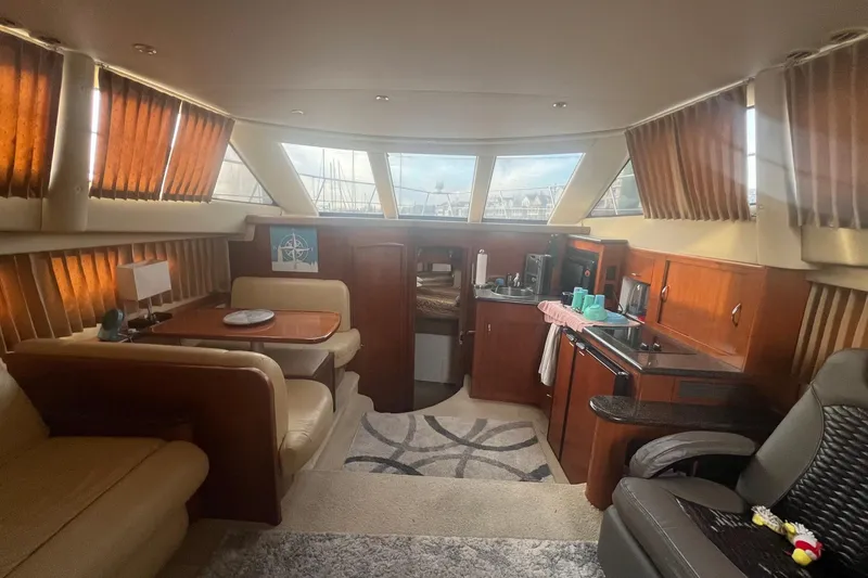 Slide: The Image of Interior of 2004 Carver 366 Motor Yacht with cozy seating and kitchenette. - 17
