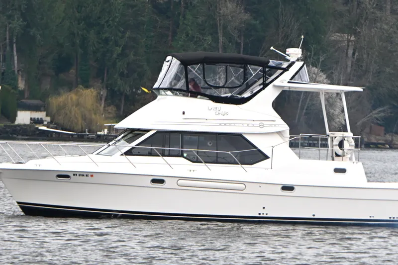 Slide: The Image of 1996 Bayliner 4087 Aft Cabin Motoryacht cruising on a calm lake. - 11