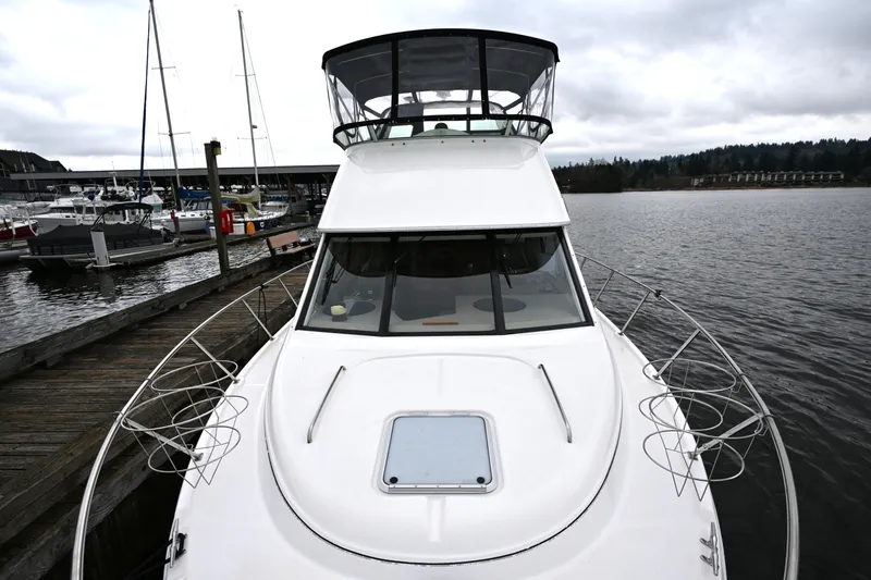 Slide: The Image of 1996 Bayliner 4087 Aft Cabin Motoryacht docked at a marina on a cloudy day. - 15