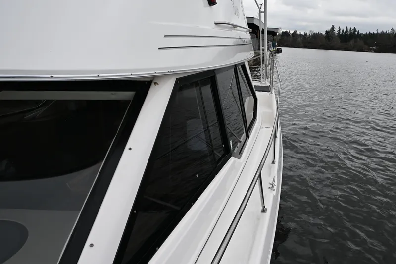 Slide: The Image of 1996 Bayliner 4087 Aft Cabin Motoryacht on calm water, side view. - 18