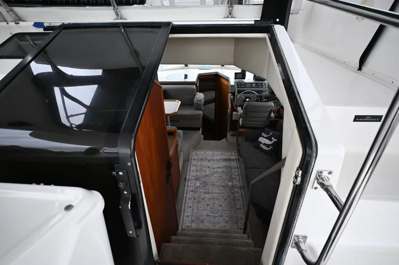 Slide: The Image of Interior view of 1996 Bayliner 4087 Aft Cabin Motoryacht, featuring helm and seating area. - 25
