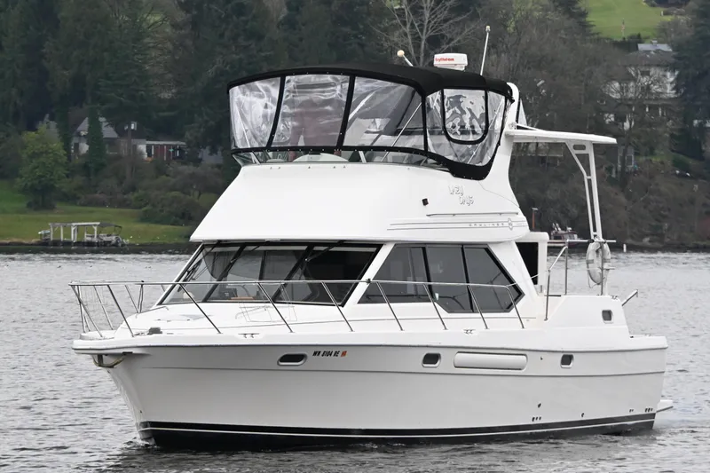 Slide: The Image of 1996 Bayliner 4087 Aft Cabin Motoryacht cruising on a serene lake. - 3