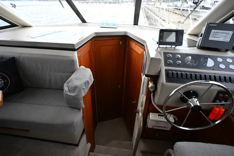 Slide: The Image of 1996 Bayliner 4087 Aft Cabin Motoryacht helm with steering wheel and navigation equipment. - 30