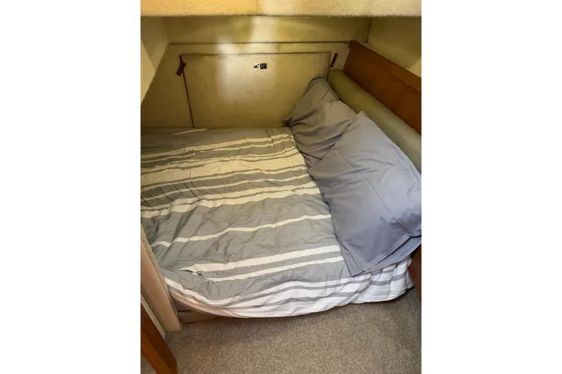 Slide: The Image of Cozy cabin bed in 1996 Bayliner 4087 Aft Cabin Motoryacht with striped bedding. - 31