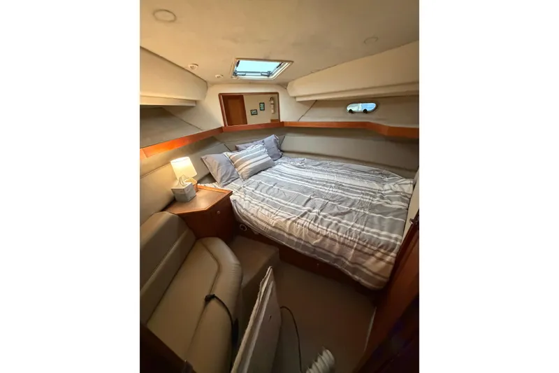 Slide: The Image of Cozy bedroom in 1996 Bayliner 4087 Aft Cabin Motoryacht with striped bedding and soft lighting. - 32