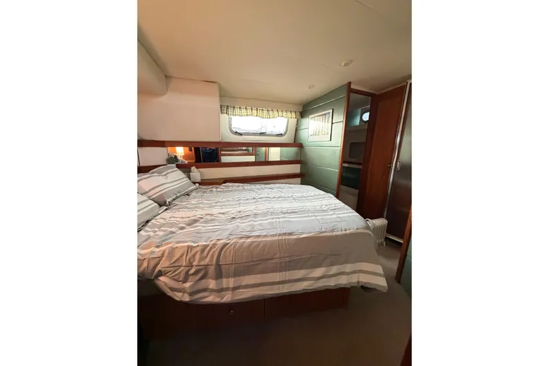 Slide: The Image of Cozy bedroom in 1996 Bayliner 4087 Aft Cabin Motoryacht with striped bedding. - 37