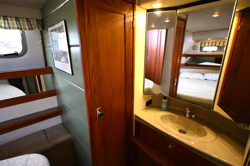 Slide: The Image of 1996 Bayliner 4087 Aft Cabin Motoryacht interior with wood cabinetry and vanity sink. - 42