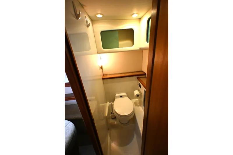 Slide: The Image of 1996 Bayliner 4087 Aft Cabin Motoryacht bathroom with toilet and storage shelves. - 44