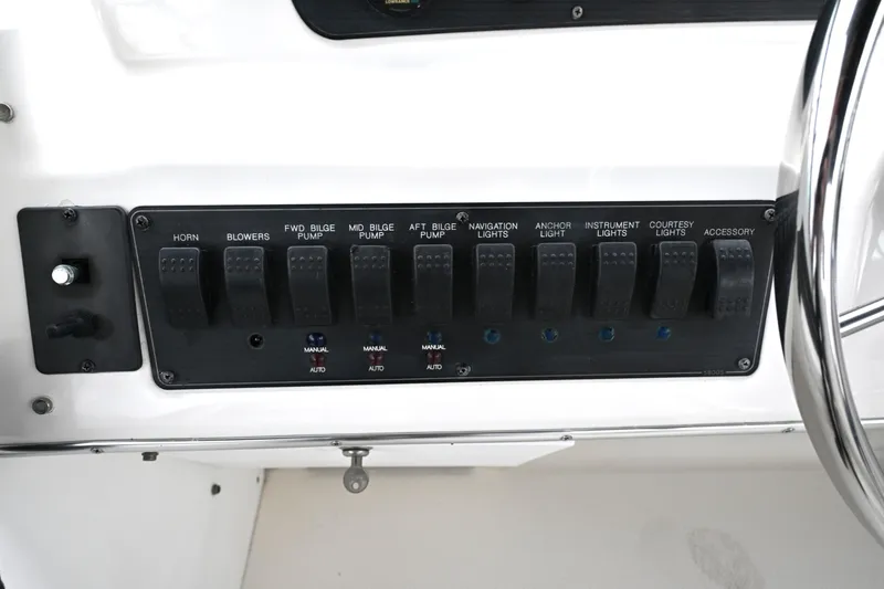 Slide: The Image of Control panel of a 1996 Bayliner 4087 Aft Cabin Motoryacht with labeled switches. - 62