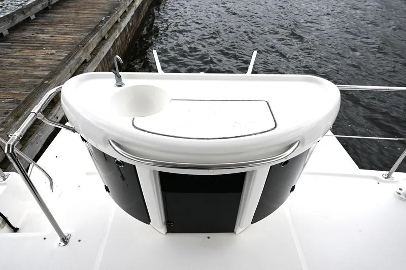 Slide: The Image of 1996 Bayliner 4087 Aft Cabin Motoryacht deck with sink and storage, dockside view. - 63