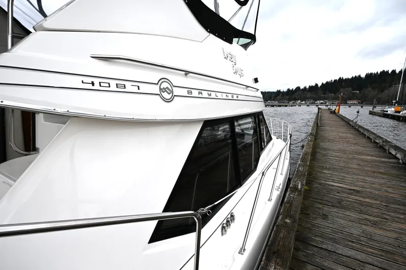 Slide: The Image of 1996 Bayliner 4087 Aft Cabin Motoryacht docked by a wooden pier. - 64