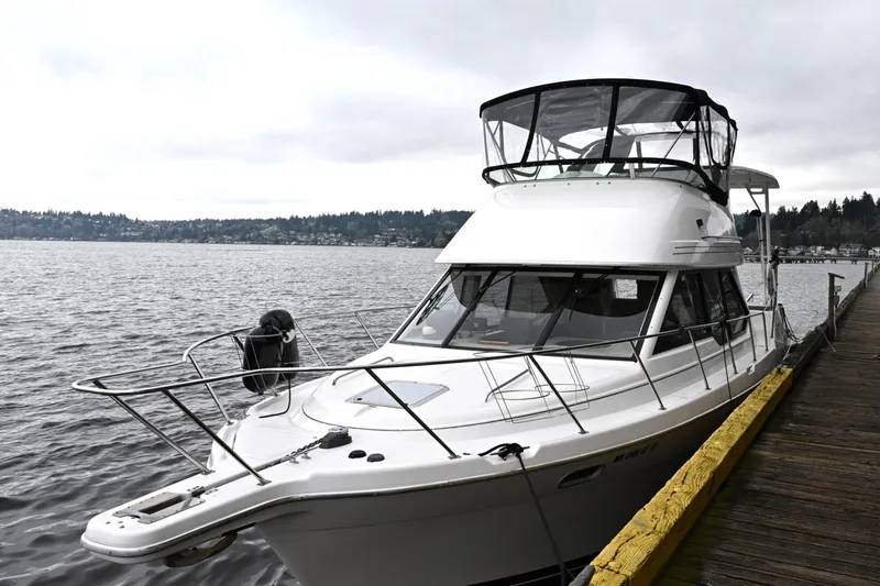 Slide: The Image of 1996 Bayliner 4087 Aft Cabin Motoryacht docked by a scenic waterfront. - 7