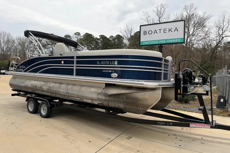 The Image of 2025 Harris Sunliner 230 pontoon boat on trailer at Boateka dealership. - 0