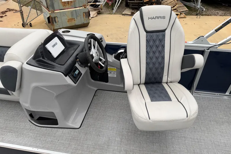 Slide: The Image of 2025 Harris Sunliner 230 boat interior with steering console and luxurious captain's chair. - 5