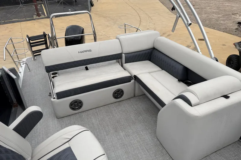 Slide: The Image of 2025 Harris Sunliner 230 pontoon boat interior with plush seating and modern design. - 6