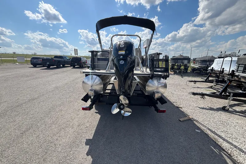 Slide: The Image of 2026 Berkshire 22UL LE B pontoon boat with outboard motor, parked under a sunny sky. - 12