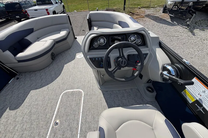Slide: The Image of 2026 Berkshire 22UL LE B pontoon boat interior with steering console and seating. - 5